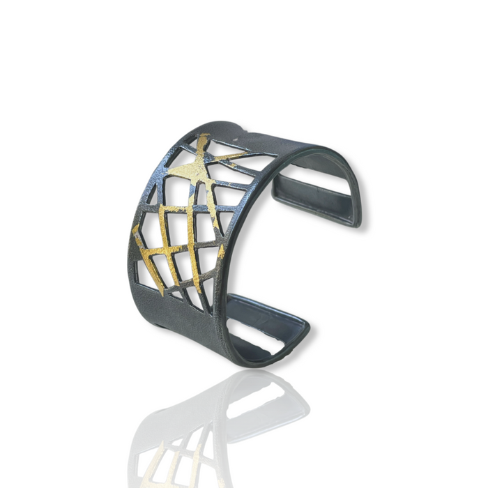 Cuff bracelet in oxidized Sterling Silver fused with 23K Gold