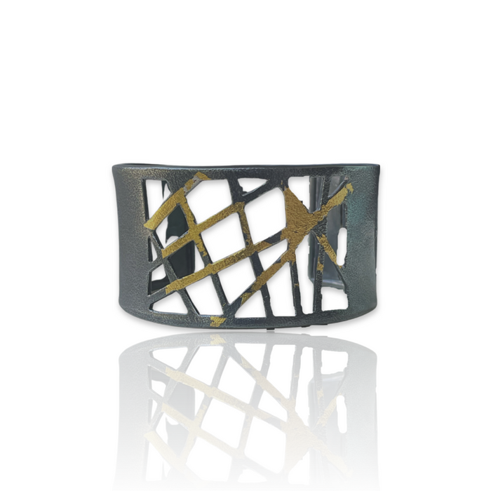 Cuff bracelet in oxidized Sterling Silver fused with 23K Gold